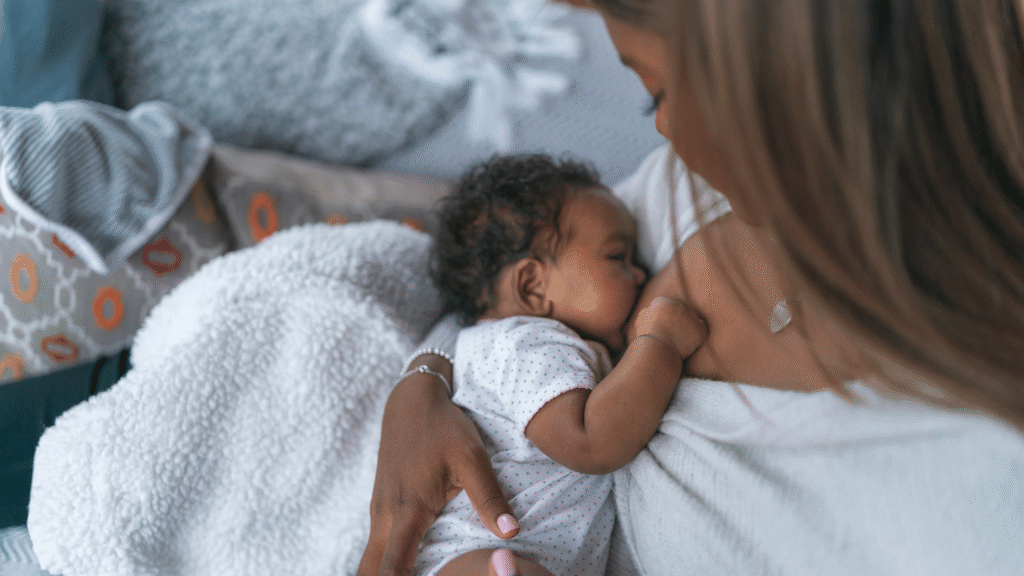 a new mom breastfeeding her new born.